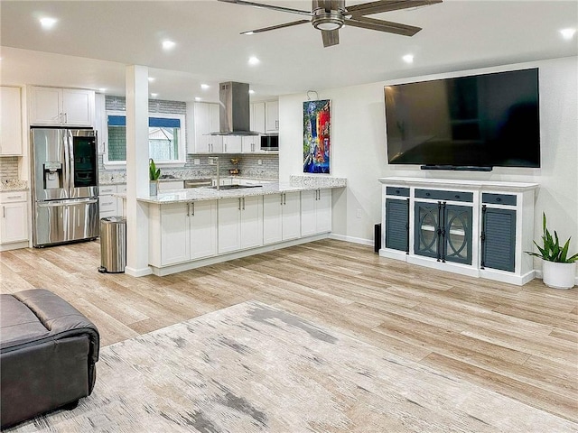 208 Bedford St, La Place, LA 70068 - kitchen with appliances with stainless steel finishes, ventilation hood, open floor plan, light wood-style flooring, and ceiling fan