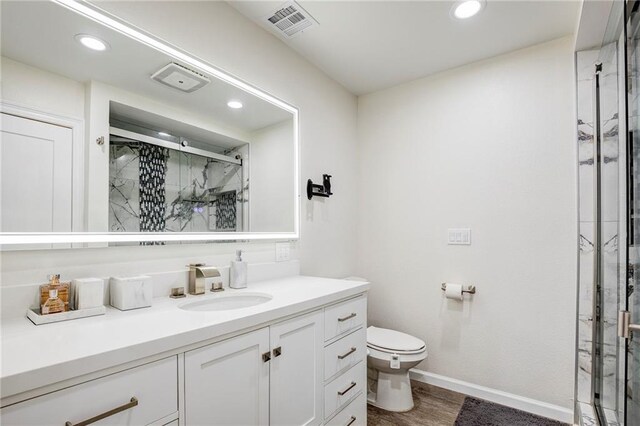 208 Bedford St, La Place, LA 70068 - bathroom featuring toilet, a marble finish shower, vanity, recessed lighting, and baseboards