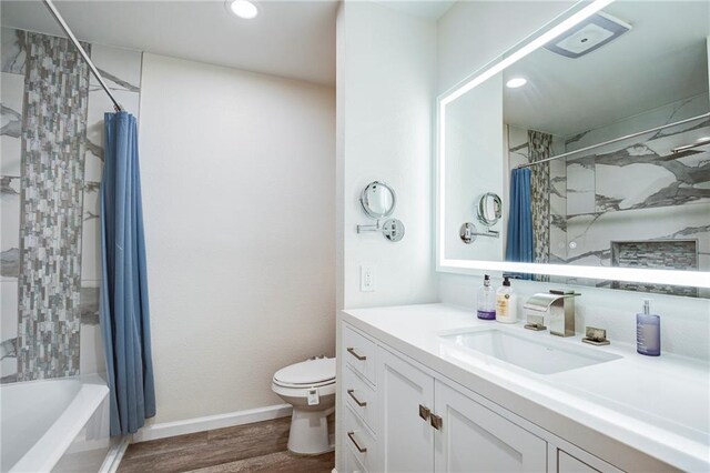 208 Bedford St, La Place, LA 70068 - full bathroom featuring toilet, vanity, wood finished floors, shower / bath combo with shower curtain, and recessed lighting