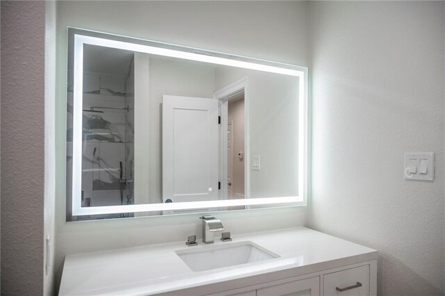 208 Bedford St, La Place, LA 70068 - bathroom with vanity, a stall shower, and a textured wall
