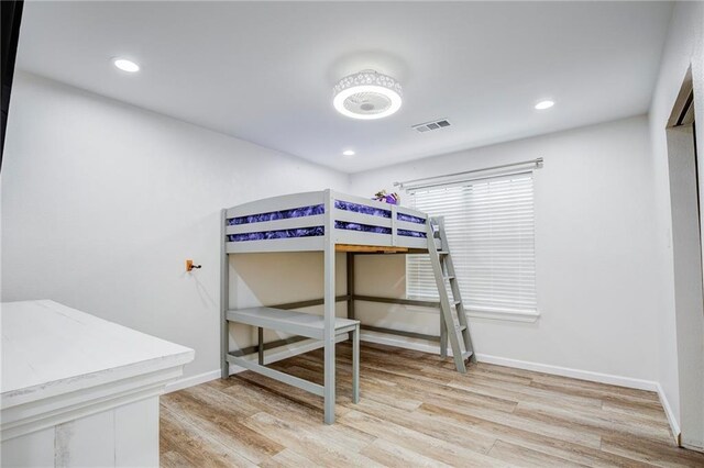 208 Bedford St, La Place, LA 70068 - bedroom featuring light wood-type flooring, baseboards, and recessed lighting