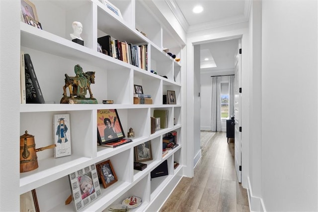 hallway featuring recessed lighting, wood finished floors, and crown molding