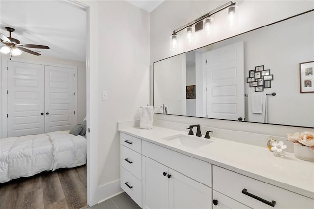 bathroom featuring ceiling fan, vanity, and baseboards