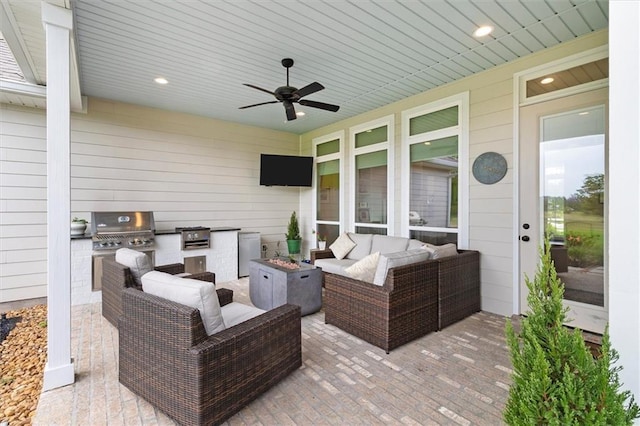 view of patio with an outdoor living space with a fire pit, ceiling fan, exterior kitchen, and grilling area