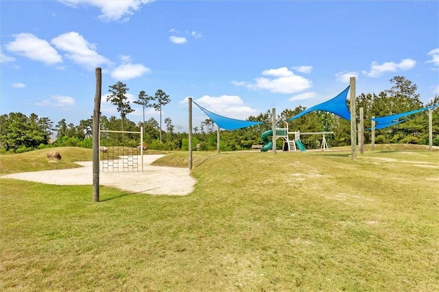 communal playground with volleyball court and a lawn