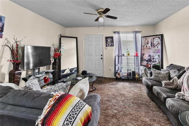 living area featuring ceiling fan, carpet floors, and a textured ceiling