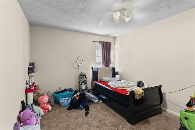 carpeted bedroom featuring a textured ceiling and ceiling fan