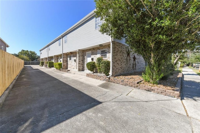 2628 Lepage St Unit 2628, New Orleans, LA 70119 - view of home's exterior with brick siding and fence