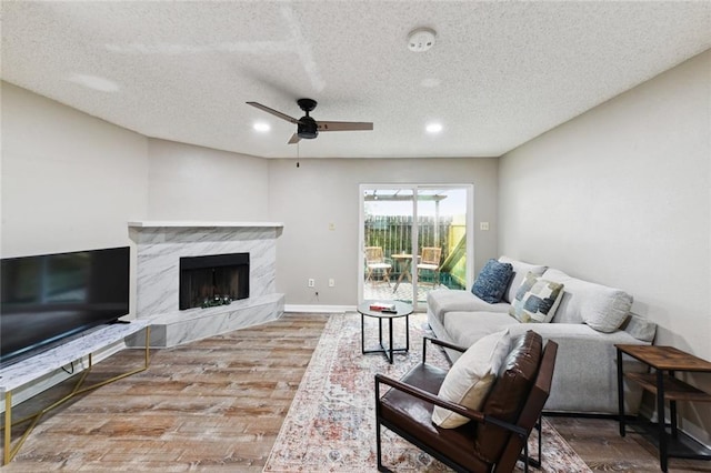2628 Lepage St Unit 2628, New Orleans, LA 70119 - living area with wood finished floors, a textured ceiling, recessed lighting, a fireplace, and ceiling fan