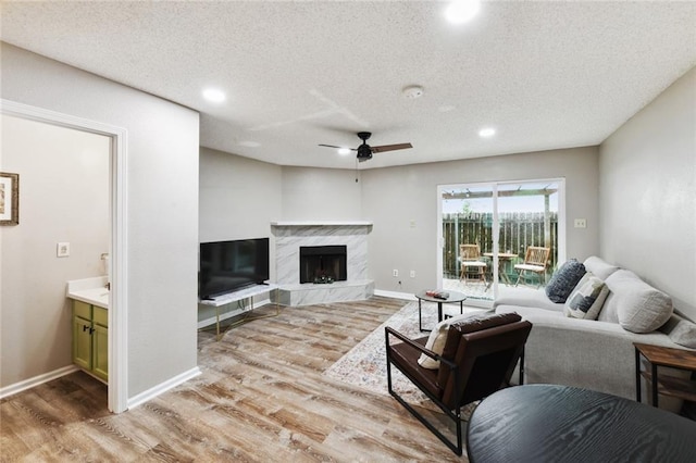 2628 Lepage St Unit 2628, New Orleans, LA 70119 - living area featuring light wood-style flooring, a fireplace, ceiling fan, and recessed lighting