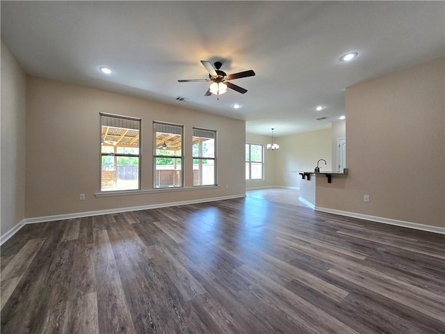 1012 Berkshire Dr, Pearl River, LA 70452 - unfurnished living room featuring visible vents, baseboards, and ceiling fan with notable chandelier