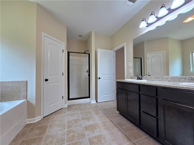 1012 Berkshire Dr, Pearl River, LA 70452 - bathroom with a sink, double vanity, visible vents, a stall shower, and a garden tub