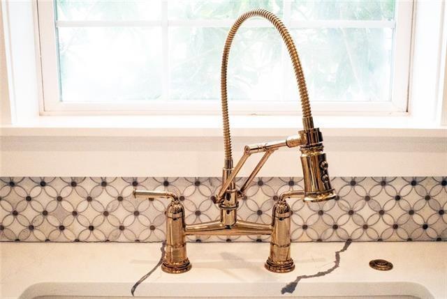 interior details featuring white cabinets, light countertops, and a sink