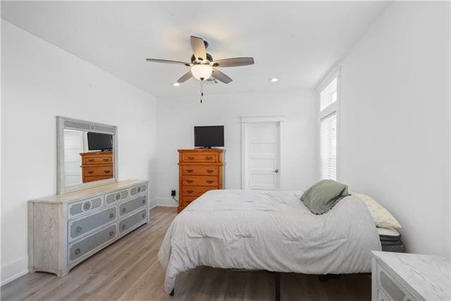 bedroom featuring ceiling fan, recessed lighting, light wood-style flooring, and baseboards