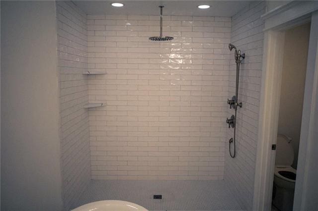 bathroom featuring recessed lighting, a stall shower, and toilet