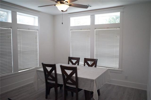 dining space with a wealth of natural light, a ceiling fan, and baseboards