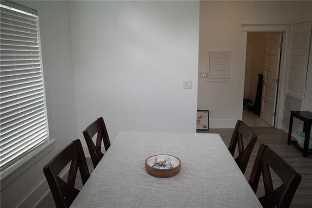 dining area featuring wood finished floors and baseboards