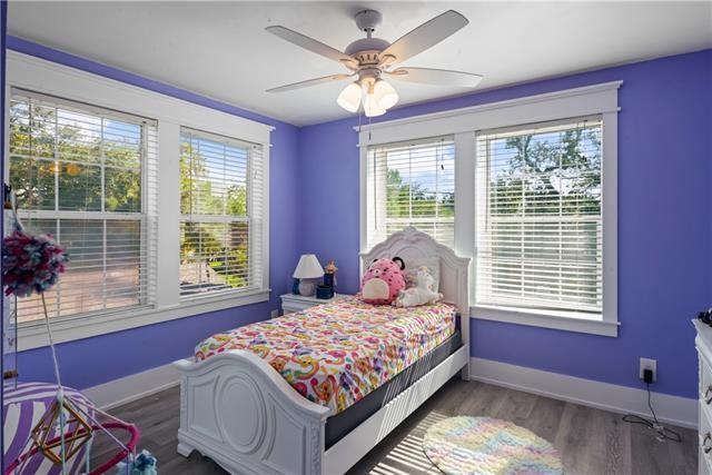 bedroom with wood finished floors, ceiling fan, and baseboards