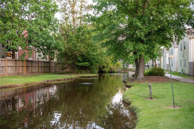 property view of water featuring fence
