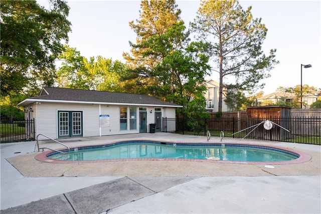 view of pool featuring fence, a patio area, french doors, and a fenced in pool
