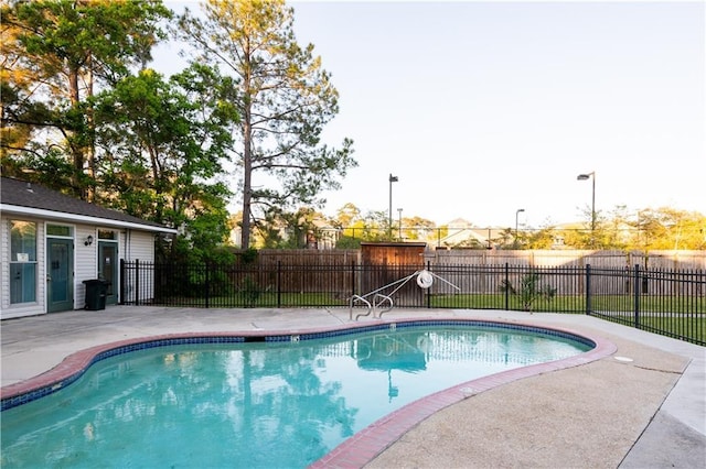 view of swimming pool featuring fence, a fenced in pool, and a patio area