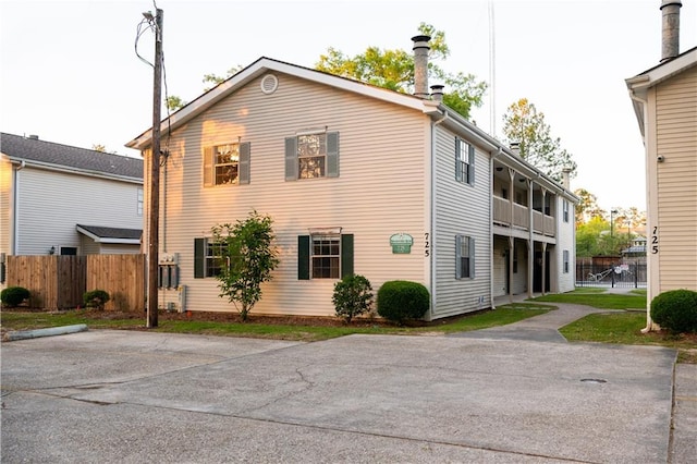 view of home's exterior with fence