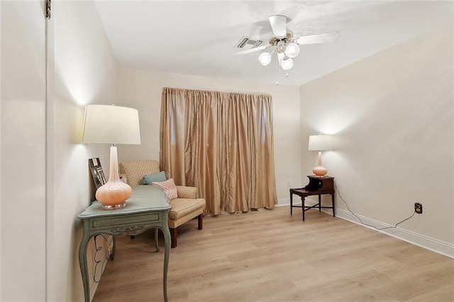 sitting room featuring wood finished floors, visible vents, a ceiling fan, and baseboards