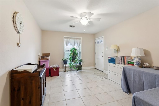 bedroom featuring light tile patterned floors, a ceiling fan, visible vents, and baseboards