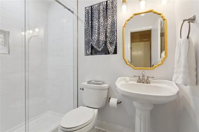 full bathroom featuring toilet and tiled shower