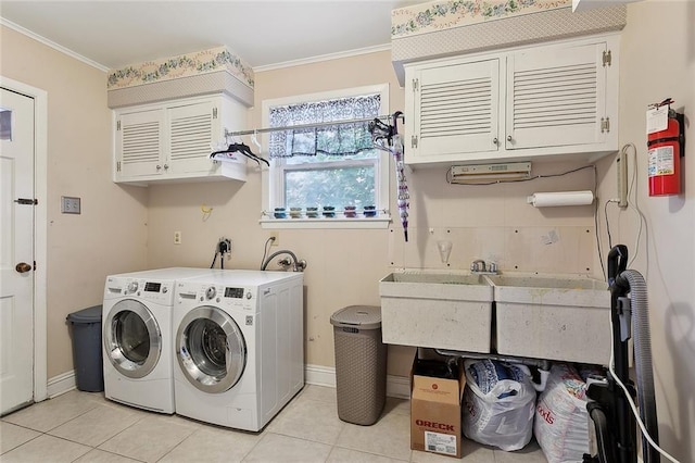 laundry room with independent washer and dryer, light tile patterned floors, cabinet space, baseboards, and crown molding
