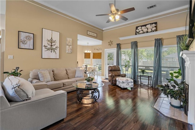 living room with wood finished floors, plenty of natural light, a ceiling fan, and crown molding