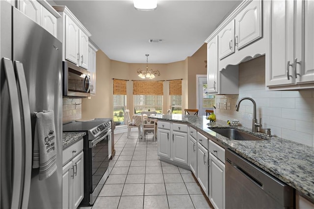 kitchen with white cabinetry, stainless steel appliances, visible vents, and a sink
