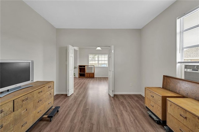 interior space with baseboards and wood finished floors