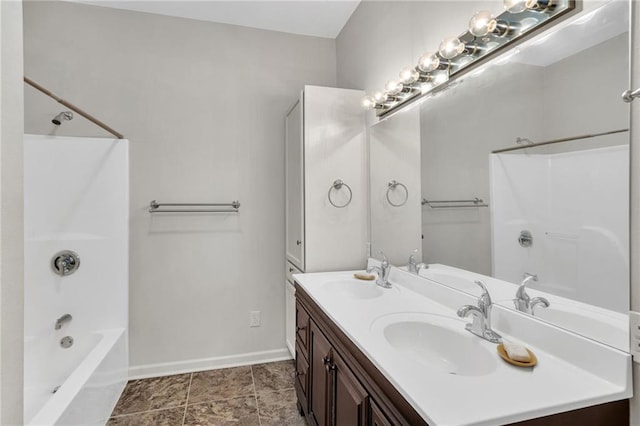 full bathroom featuring double vanity, a sink, bathing tub / shower combination, and baseboards