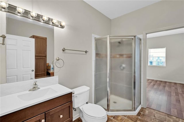 full bathroom with a shower stall, toilet, and vanity