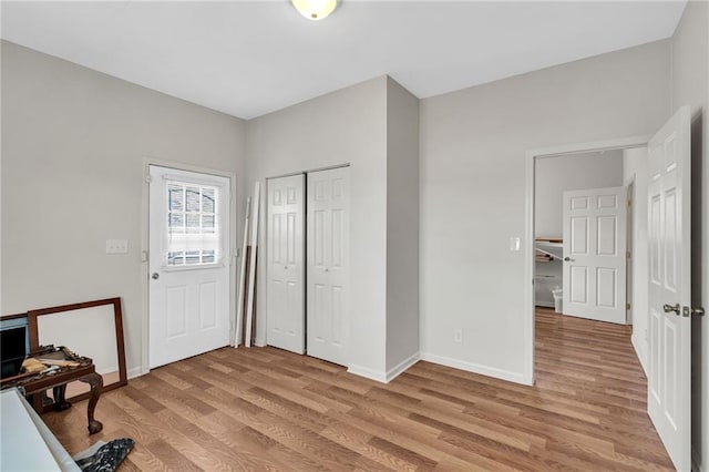 entryway with light wood-style floors and baseboards