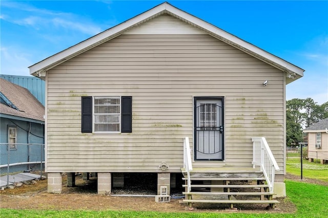 rear view of house featuring a lawn