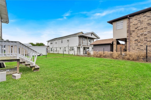 view of yard featuring fence and a deck