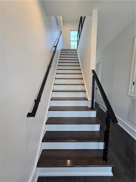 5453 Chartres St, New Orleans, LA 70117 - stairway featuring wood finished floors and baseboards
