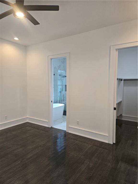 5453 Chartres St, New Orleans, LA 70117 - unfurnished bedroom with dark wood-style flooring, a walk in closet, recessed lighting, ensuite bathroom, and a closet