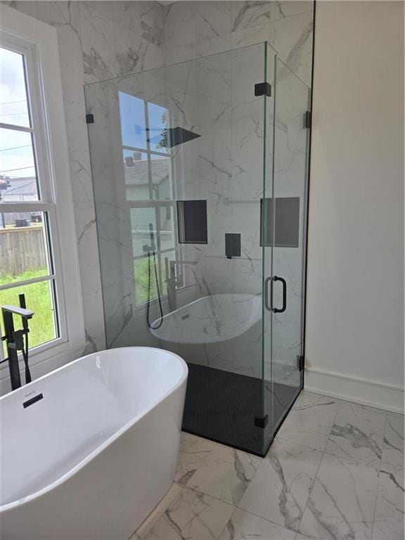 5453 Chartres St, New Orleans, LA 70117 - full bathroom featuring marble finish floors, a freestanding bath, and a marble finish shower