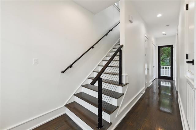 stairway featuring wood finished floors, recessed lighting, and baseboards