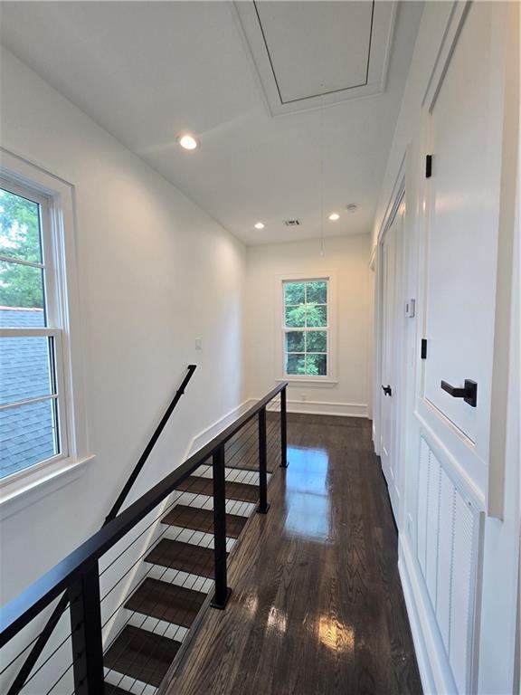 5453 Chartres St, New Orleans, LA 70117 - hall featuring attic access, an upstairs landing, dark wood-style floors, and recessed lighting