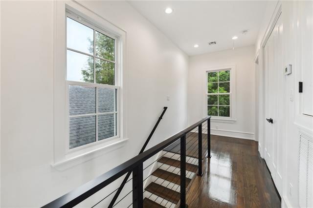 hallway with baseboards, recessed lighting, an upstairs landing, dark wood-style floors, and visible vents