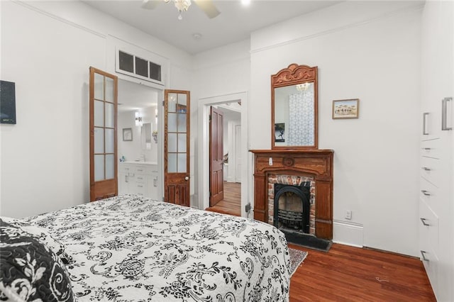 2639 Desoto St, New Orleans, LA 70119 - bedroom with visible vents, wood finished floors, a ceiling fan, and a brick fireplace