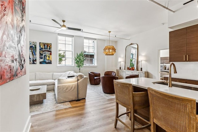 dining room with ceiling fan and light wood-style floors