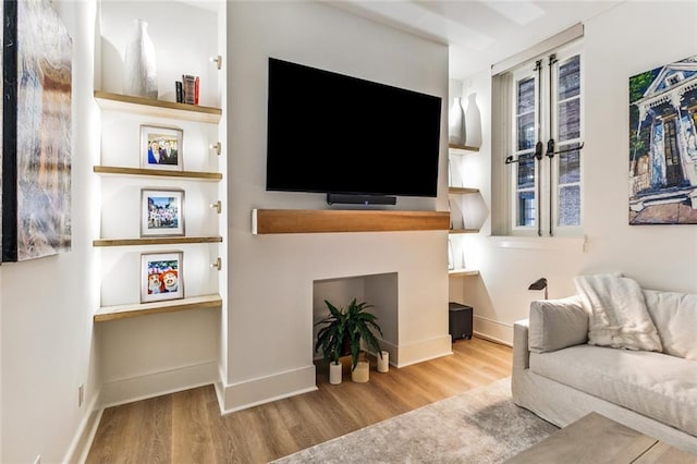living area featuring wood finished floors and baseboards
