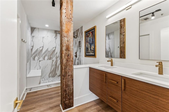 full bath with walk in shower, a sink, and visible vents