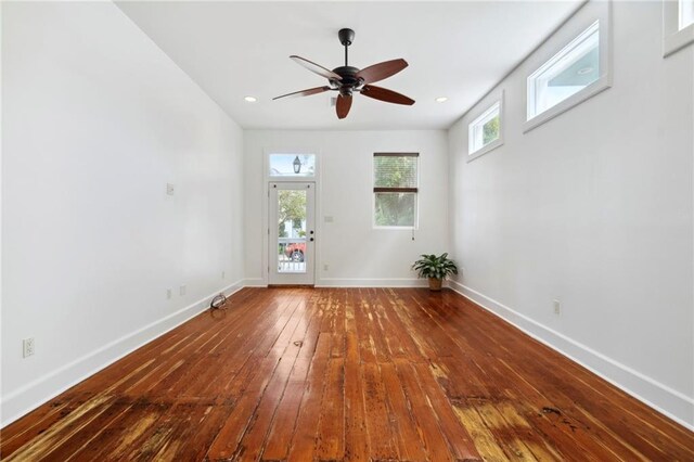 empty room with ceiling fan, hardwood / wood-style floors, recessed lighting, and baseboards