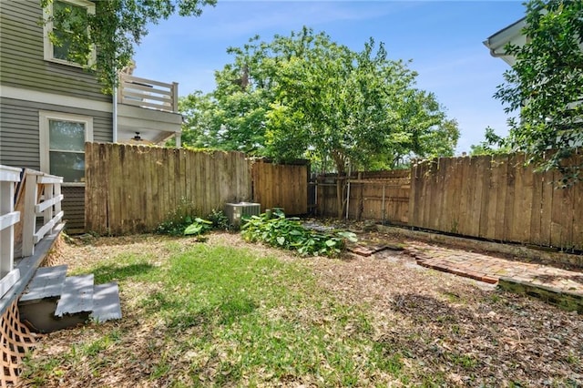 view of yard with cooling unit and fence